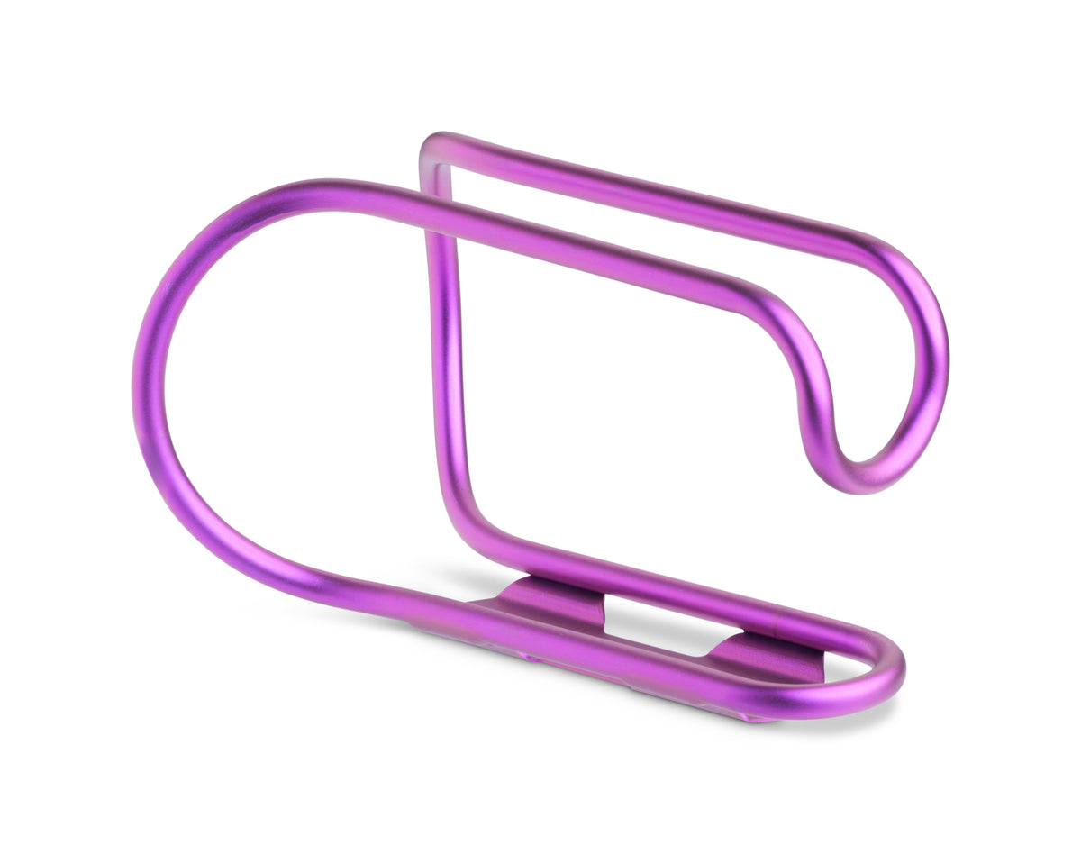 A metallic purple bicycle bottle cage with a sleek, curved design, shown on a clean white background.