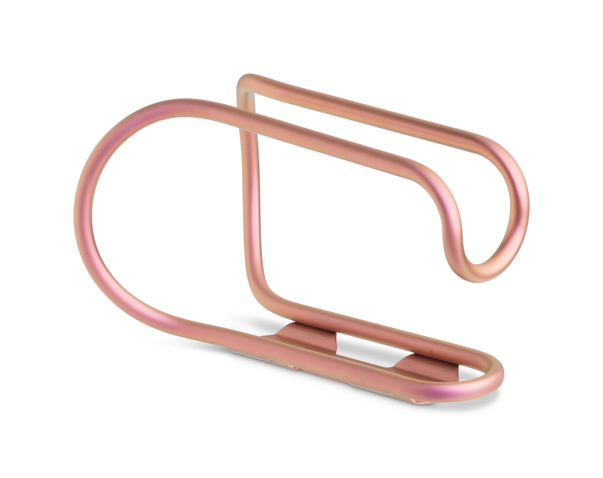 A minimalist titanium bicycle bottle cage in pink, shown on a clean white background.