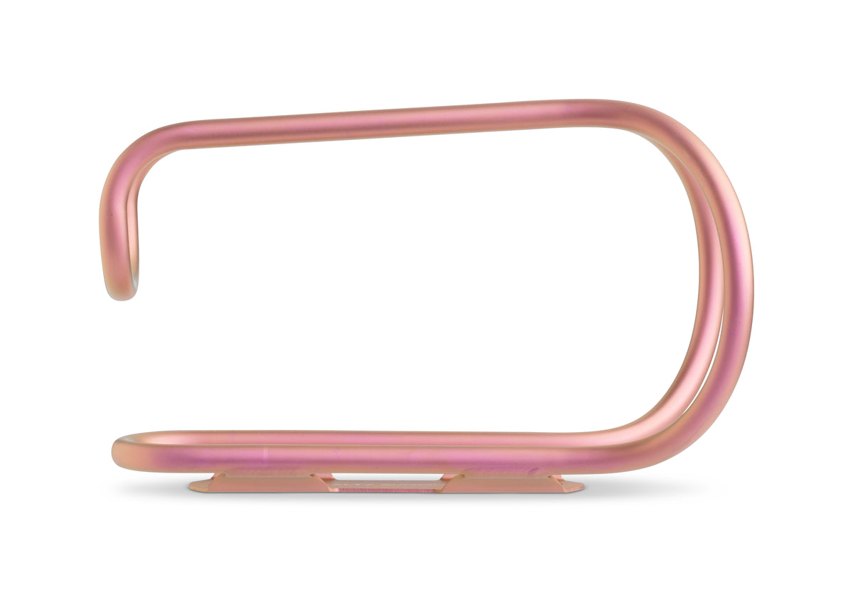 A titanium pink bottle cage, shown on a clean white background.