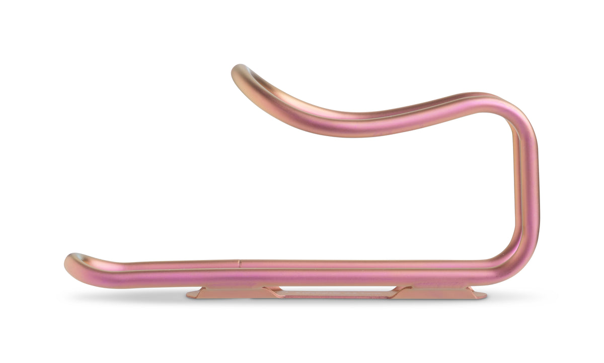 A metallic pink bicycle bottle cage, shown on a clean white background.